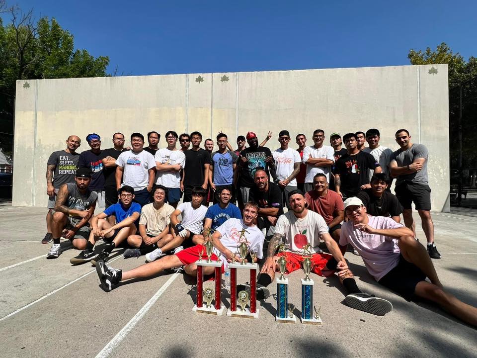 MegaWall community gathered with championship trophies at the handball courts